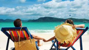 couple sitting on beach in Cancun, Mexico