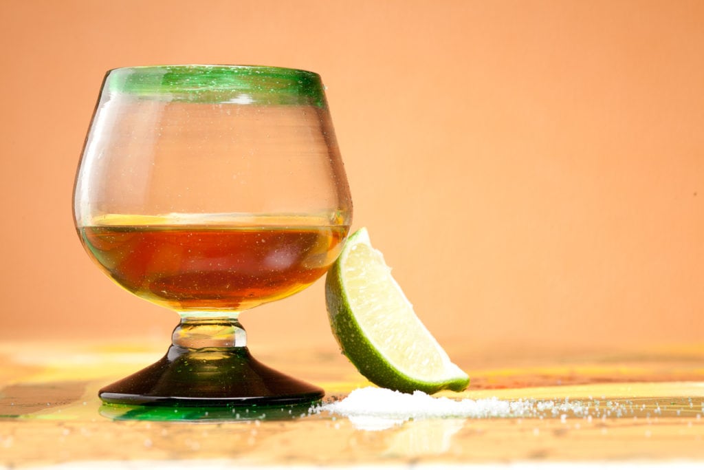 glass of tequila with lime